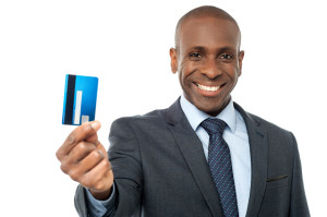 38278264 - young corporate guy showing his debit card